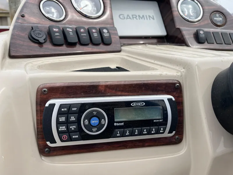 Slide: The Image of Control panel of a 2014 Avalon CATALINA 22 boat with Garmin and Jensen systems. - 12