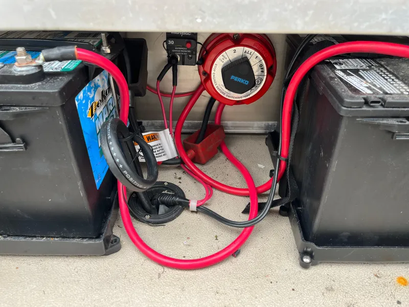 Slide: The Image of Battery compartment of 2014 Avalon CATALINA 22 with red cables and switch. - 17