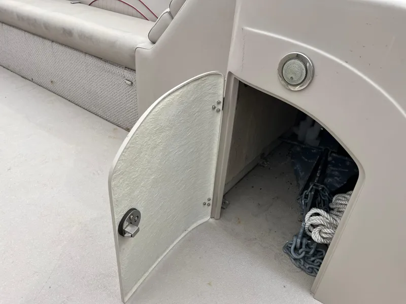 Slide: The Image of Open storage compartment on 2014 Avalon CATALINA 22 boat, showing anchor and rope. - 18