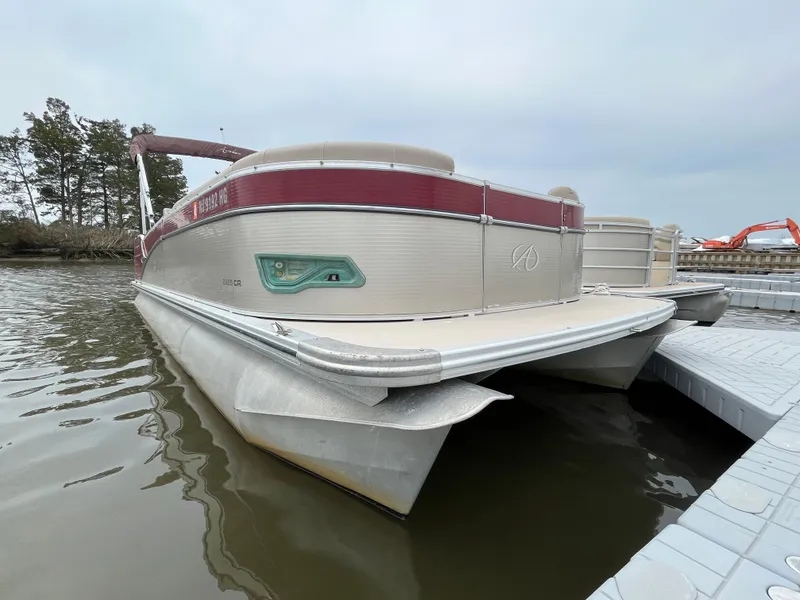 Slide: The Image of 2014 Avalon CATALINA 22 pontoon boat docked on calm water. - 3