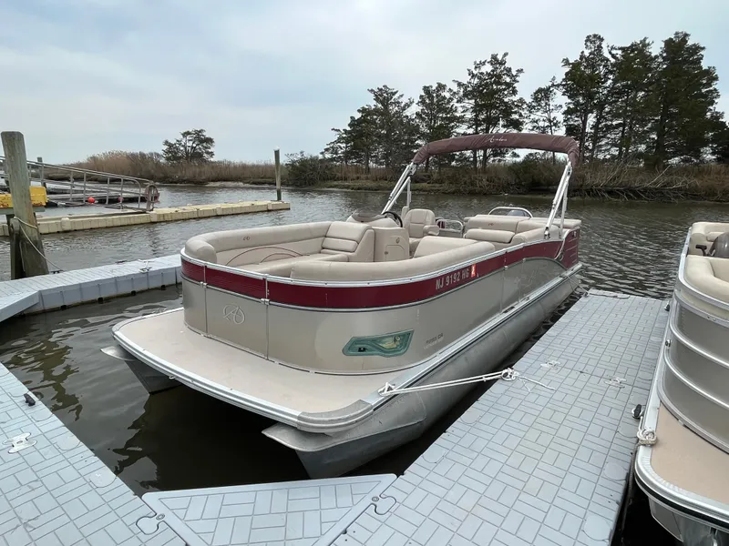 Slide: The Image of 2014 Avalon CATALINA 22 pontoon boat docked on a calm lake. - 5