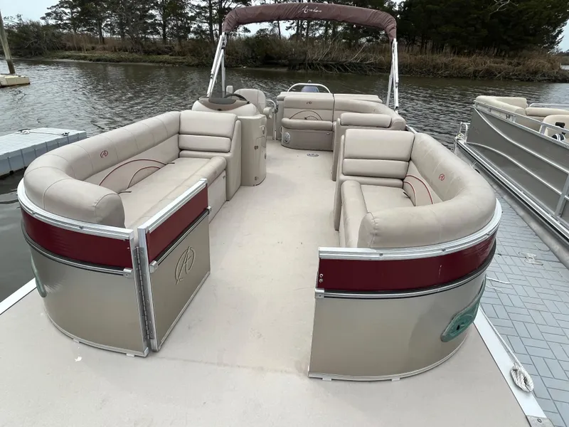 Slide: The Image of 2014 Avalon CATALINA 22 pontoon boat with spacious seating on a calm waterway. - 6