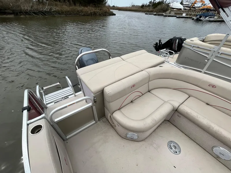 Slide: The Image of 2014 Avalon CATALINA 22 pontoon boat with beige seating, docked on a calm river. - 8