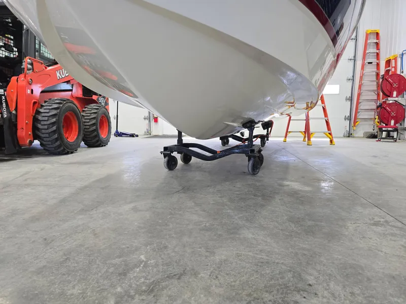 Slide: The Image of 2019 Larson LX 225 IO boat in a garage with equipment and ladders. - 16