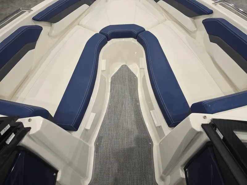 Slide: The Image of 2019 Larson LX 225 IO boat interior with blue and white seating. - 2