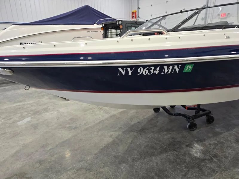 Slide: The Image of 2019 Larson LX 225 IO boat with registration NY 9634 MN in a showroom. - 32