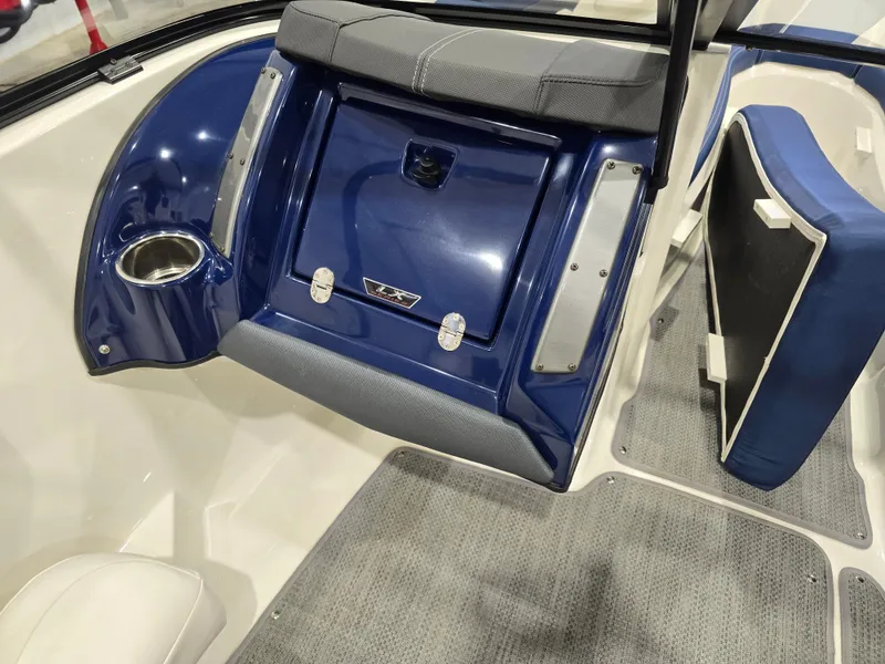 Slide: The Image of 2019 Larson LX 225 IO boat interior with blue and gray seating and carpeted flooring. - 37