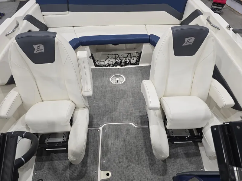 Slide: The Image of 2019 Larson LX 225 IO boat interior with two white seats and gray carpet. - 4