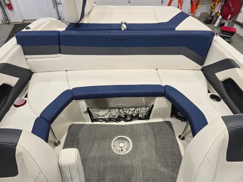 Slide: The Image of Interior of a 2019 Larson LX 225 IO boat with blue and white seating. - 7
