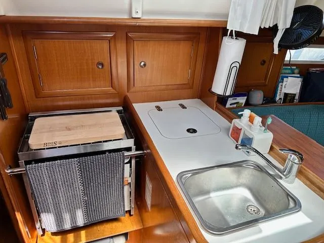Slide: The Image of Compact kitchen area in a 2000 Beneteau Oceanis 311 sailboat with sink and storage. - 17