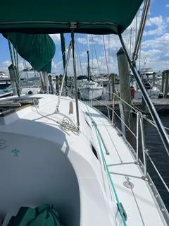 Slide: The Image of Beneteau Oceanis 311 sailboat docked at marina, 2000 model, sunny day, green canopy. - 27