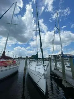 Slide: The Image of Beneteau Oceanis 311 sailboat docked under a partly cloudy sky, 2000 model. - 37