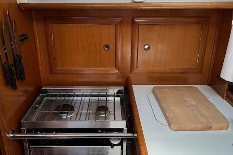 Slide: The Image of Galley kitchen in 2000 Beneteau Oceanis 311 sailboat with stove and cutting board. - 39