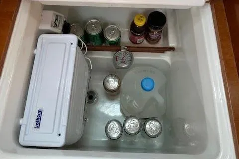 Slide: The Image of Storage compartment with drinks and supplies on a 2000 Beneteau Oceanis 311 sailboat. - 40