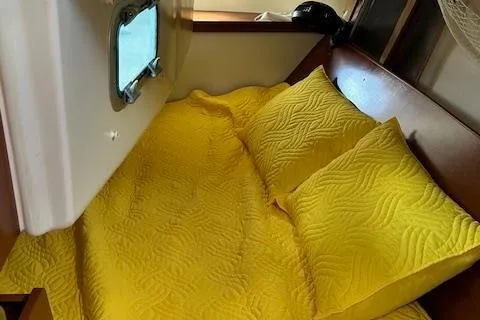 Slide: The Image of Cozy cabin bed with yellow bedding in 2000 Beneteau Oceanis 311 sailboat. - 44