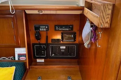 Slide: The Image of Control panel of a 2000 Beneteau Oceanis 311 sailboat, featuring navigation and communication equipment. - 45