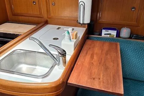 Slide: The Image of Interior of 2000 Beneteau Oceanis 311 yacht with sink and wooden table. - 49