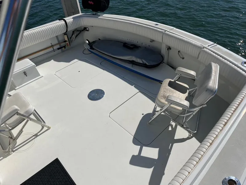 Slide: The Image of 1988 Hatteras 52 Convertible boat deck with chairs and fishing equipment. - 11