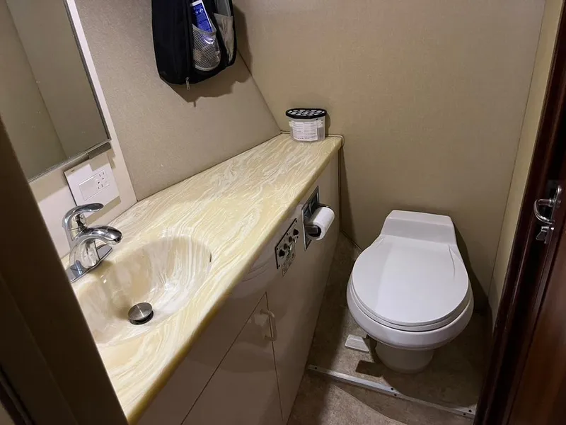Slide: The Image of Bathroom interior of 1988 Hatteras 52 Convertible yacht with sink and toilet. - 18