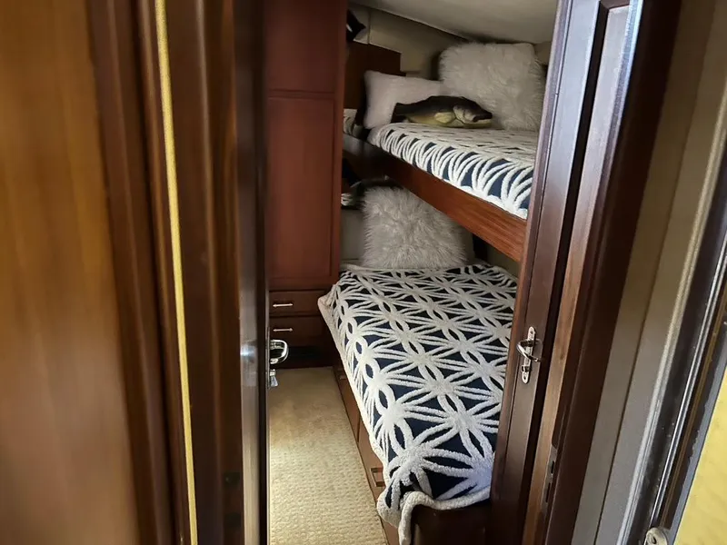 Slide: The Image of Bunk beds in 1988 Hatteras 52 Convertible yacht cabin with patterned bedding. - 19