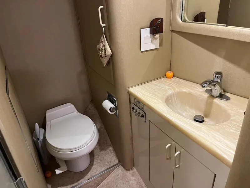 Slide: The Image of Bathroom interior of 1988 Hatteras 52 Convertible yacht, featuring sink and toilet. - 21