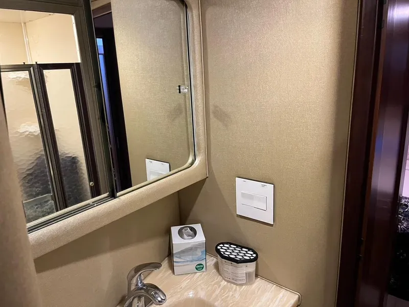 Slide: The Image of Bathroom interior of 1988 Hatteras 52 Convertible yacht with mirror and sink. - 22