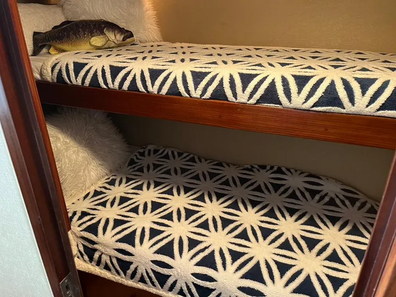 Slide: The Image of Bunk beds with patterned bedding inside a 1988 Hatteras 52 Convertible yacht cabin. - 23