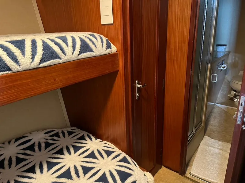 Slide: The Image of Bunk beds and bathroom in 1988 Hatteras 52 Convertible yacht interior. - 24