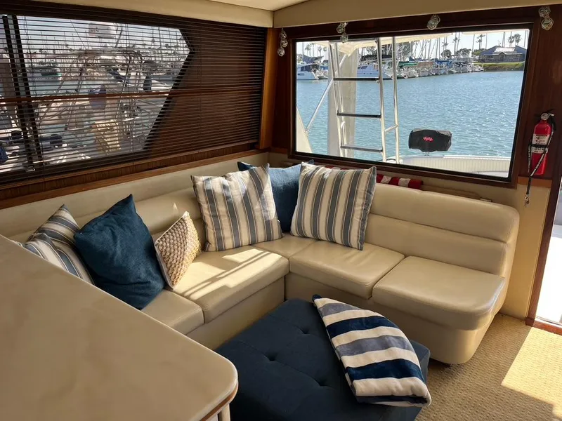 Slide: The Image of Interior of 1988 Hatteras 52 Convertible yacht with cozy seating and nautical decor. - 28