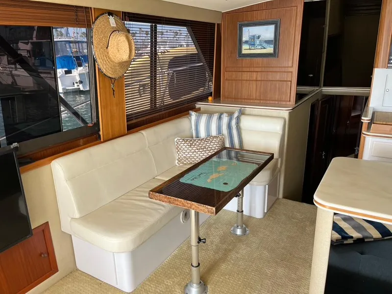 Slide: The Image of Interior of 1988 Hatteras 52 Convertible yacht with cozy seating and nautical decor. - 29
