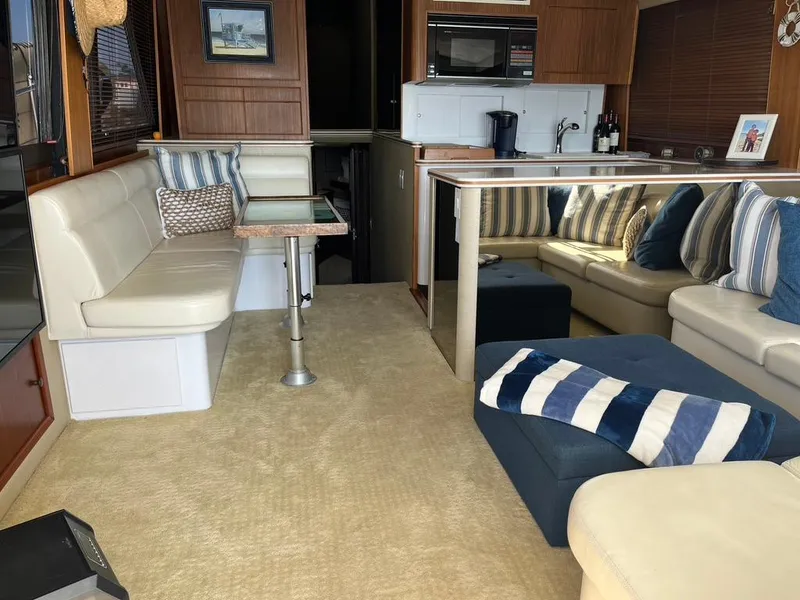 Slide: The Image of Interior of 1988 Hatteras 52 Convertible yacht with cozy seating and modern amenities. - 30