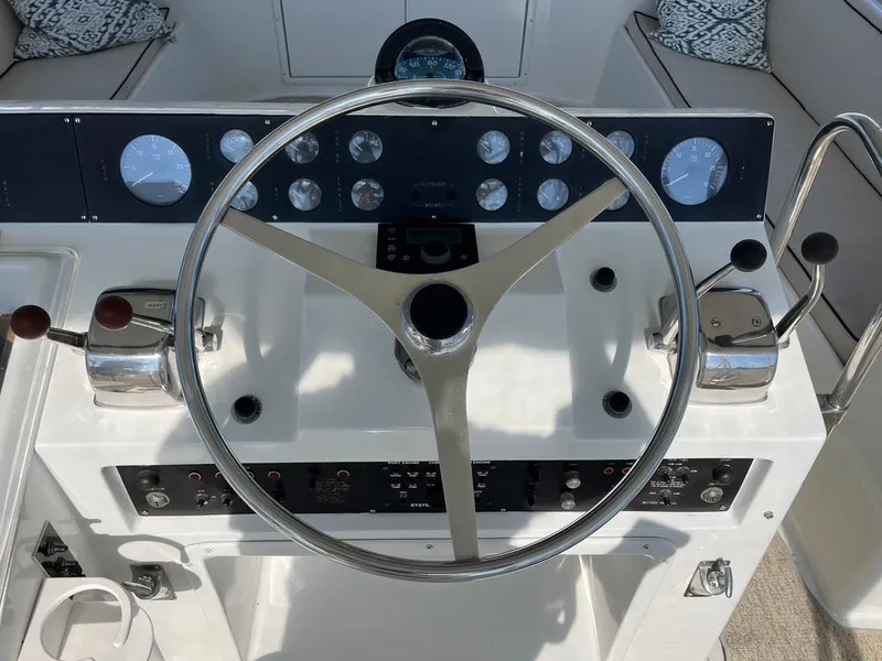 Slide: The Image of Steering wheel and controls of a 1988 Hatteras 52 Convertible yacht. - 32
