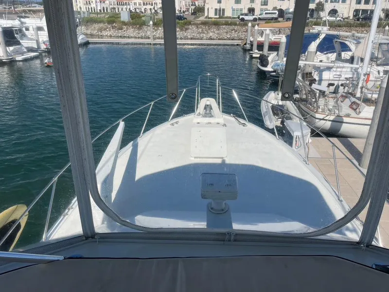 Slide: The Image of 1988 Hatteras 52 Convertible yacht docked in a marina, viewed from the helm. - 35