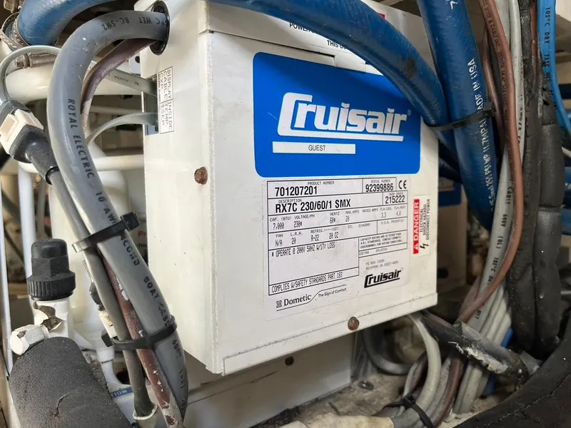 Slide: The Image of Cruisair unit in 1988 Hatteras 52 Convertible engine room, surrounded by cables and hoses. - 45