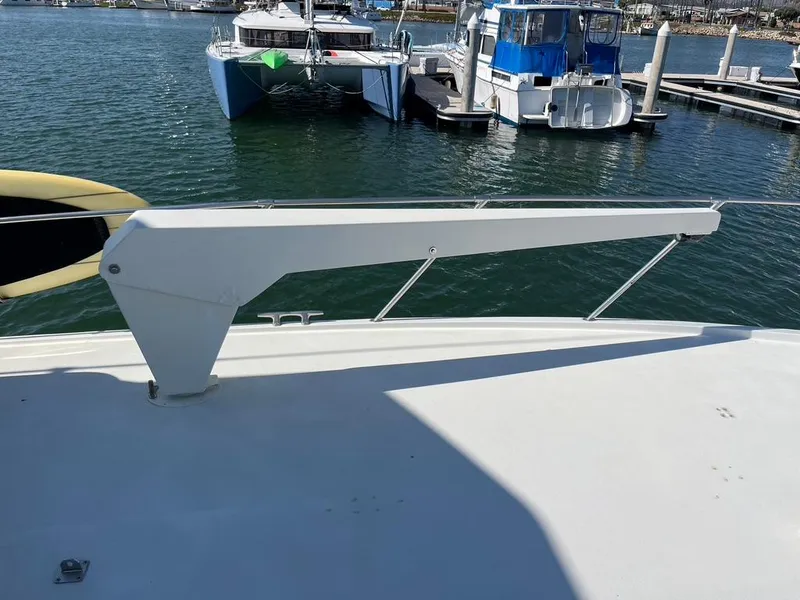 Slide: The Image of 1988 Hatteras 52 Convertible yacht deck with davit, docked in marina. - 7