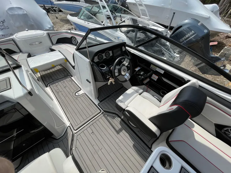 Slide: The Image of 2018 Yamaha Boats 212X interior with sleek design and modern dashboard. - 13