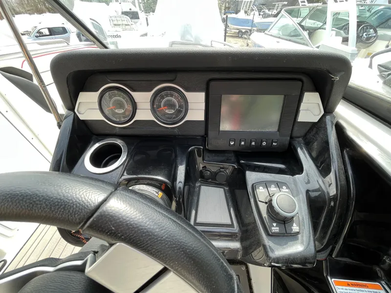 Slide: The Image of Dashboard of a 2018 Yamaha Boats 212X, featuring gauges and a control panel. - 18
