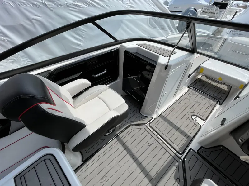 Slide: The Image of 2018 Yamaha Boats 212X interior with sleek seating and modern dashboard design. - 19