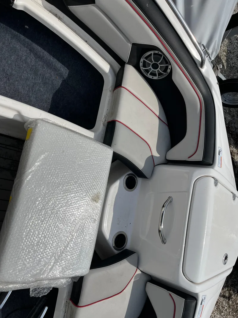 Slide: The Image of 2018 Yamaha Boats 212X interior with cushioned seating and speaker system. - 23