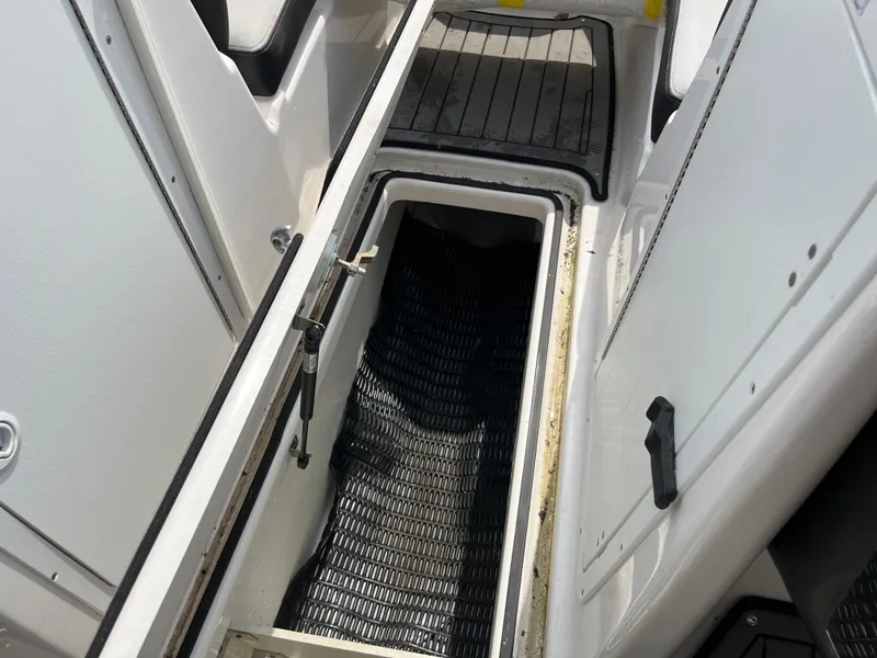 Slide: The Image of 2018 Yamaha Boats 212X interior storage compartment with open hatch. - 25