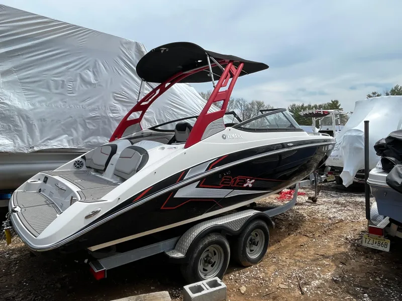 Slide: The Image of 2018 Yamaha Boats 212X on trailer, featuring sleek design and vibrant red accents. - 5