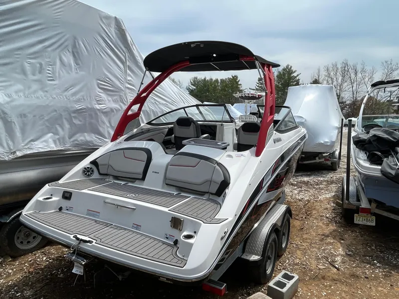 Slide: The Image of 2018 Yamaha Boats 212X on trailer, featuring sleek design and red accents. - 7