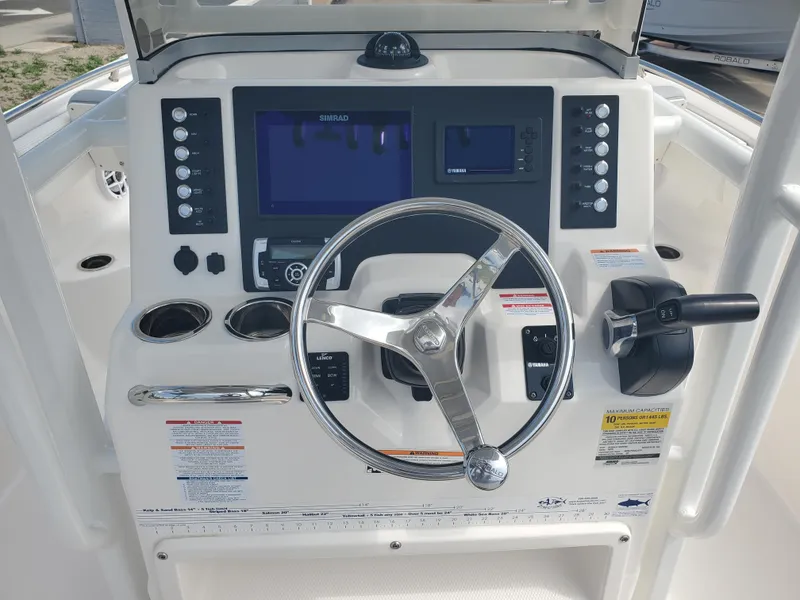 Slide: The Image of 2022 Robalo R222 Center Console dashboard with steering wheel and navigation controls. - 15