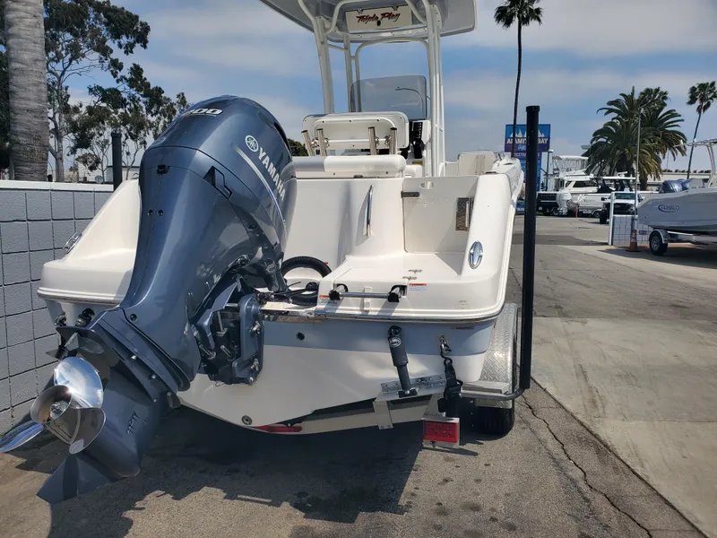 Slide: The Image of 2022 Robalo R222 Center Console boat with Yamaha outboard motor, parked outdoors. - 3