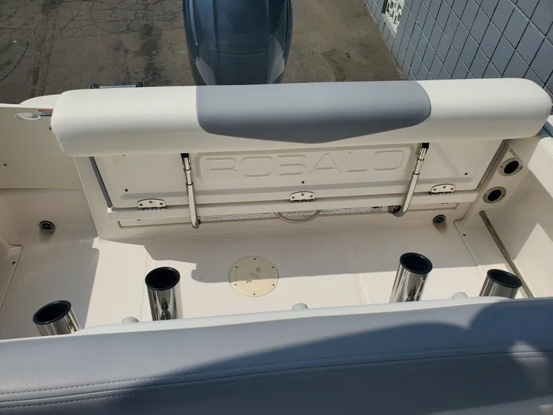 Slide: The Image of 2022 Robalo R222 Center Console boat interior with rod holders and seating. - 5