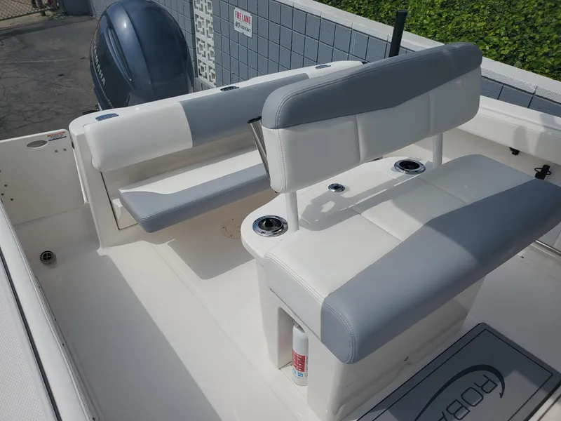 Slide: The Image of 2022 Robalo R222 Center Console boat interior with seating and engine view. - 7