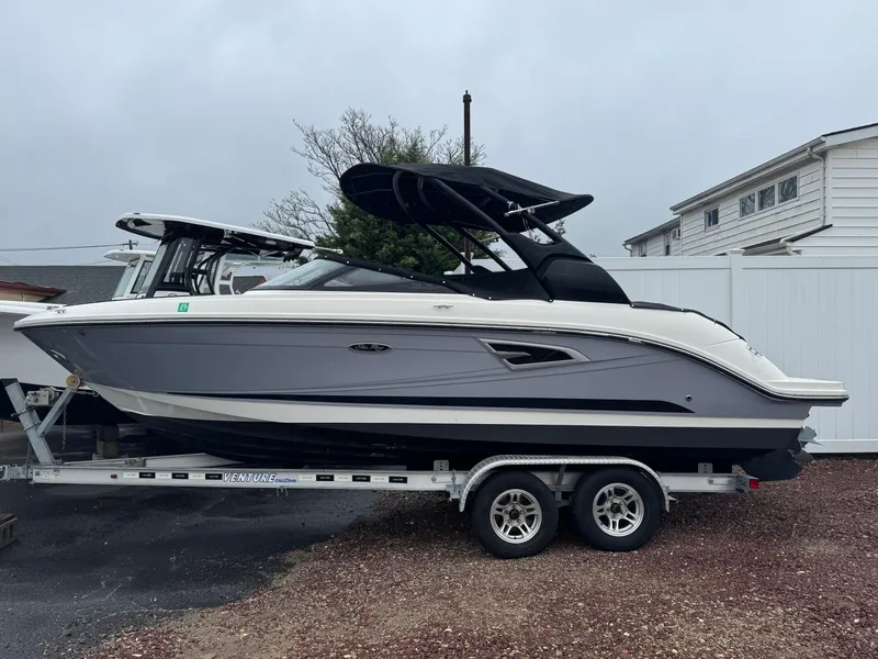 Slide: The Image of 2017 Sea Ray SLX 230 boat on trailer, parked outdoors. - 1