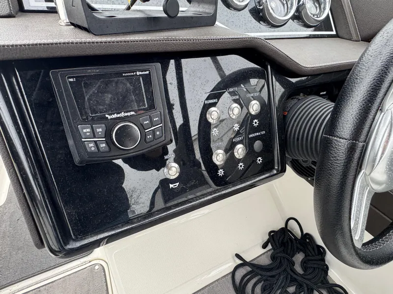 Slide: The Image of Control panel of a 2017 Sea Ray SLX 230 boat with audio system and steering wheel. - 10