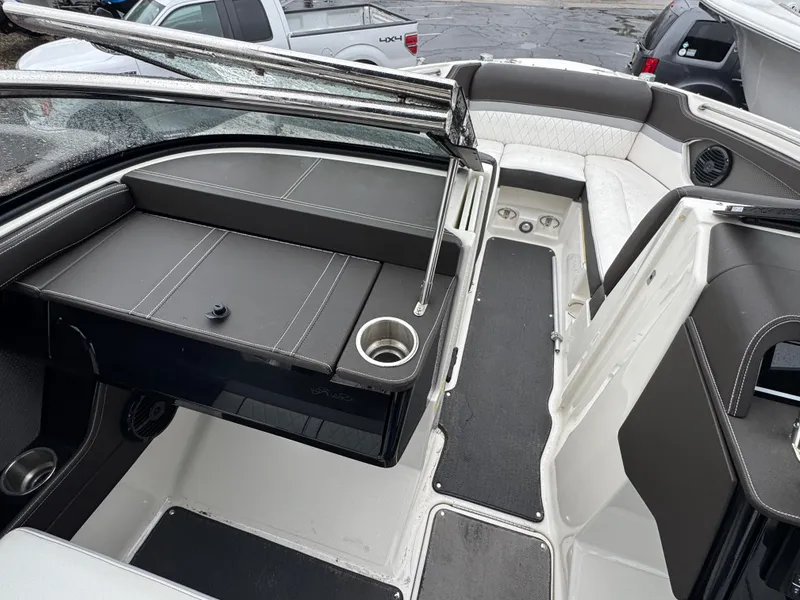 Slide: The Image of 2017 Sea Ray SLX 230 boat interior with seating and cup holders. - 13