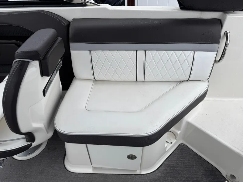 Slide: The Image of 2017 Sea Ray SLX 230 boat interior with white and black cushioned seating. - 6